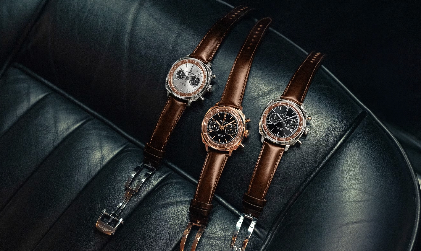 Three original Breitling Top Time Aston Martin DB5 editions displayed together